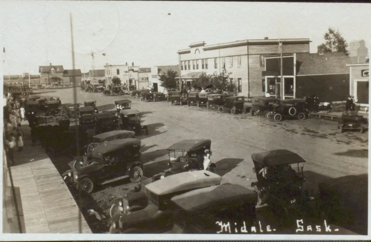 Main Street lined with parked cars, Midale, about 1920